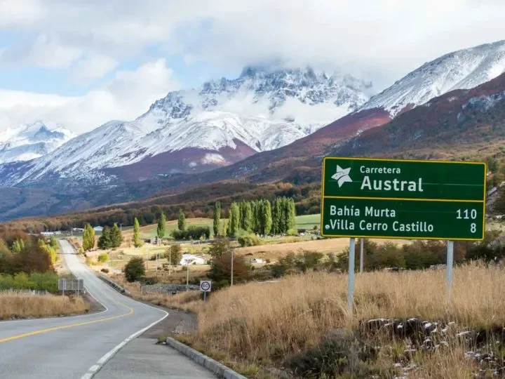 Carretera Austral road sign with snow-capped mountains in the background, near Villa Cerro Castillo